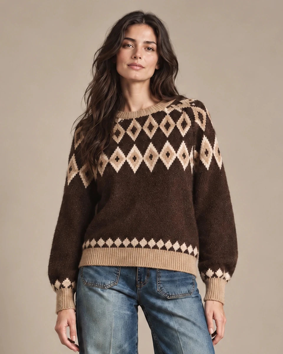 Close-up of Odessa brown sweater worn untucked, showing the diamond-knit pattern and beige ribbed hem.