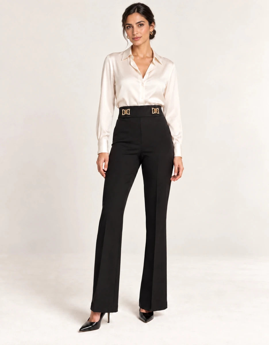 Full-length view of black Pantaloni Flared con Dettagli Laterali with gold-tone waist details, styled with an ivory blouse and black heels.