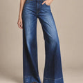 Front detail of blue Paola wide-leg jeans showing a high two-button waistband, curved front pockets and contrast stitching.