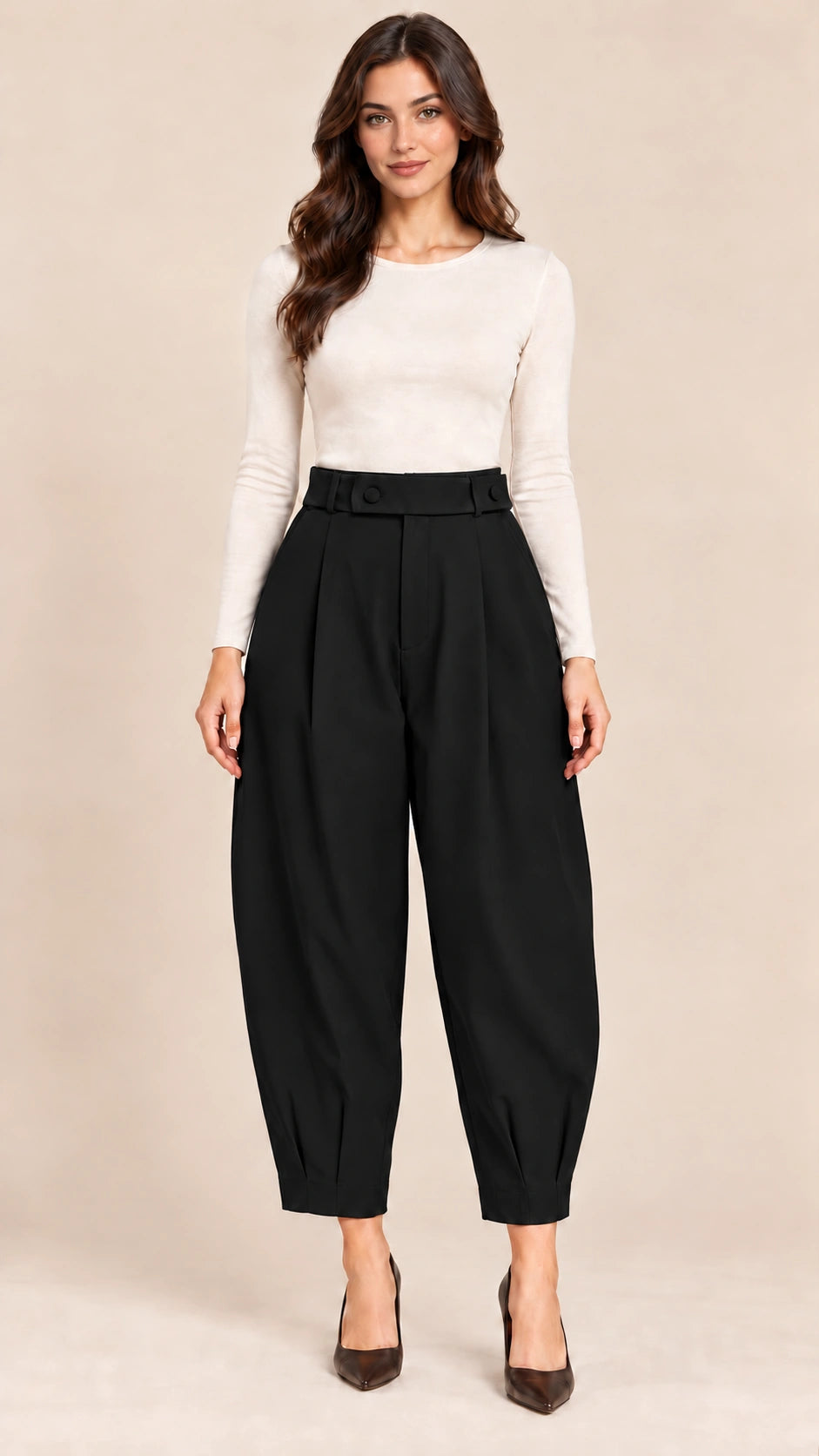 Full-length view of black Queen Nero barrel-leg trousers with a button-detail waistband and pleated ankle hems, worn with an ivory top.