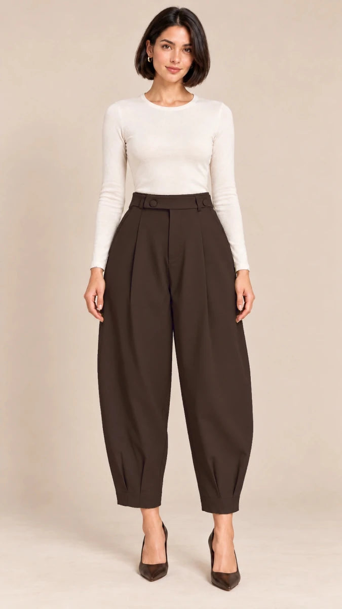 Full-length front view of deep brown Queen barrel-leg trousers with a button-detail waistband and pleated ankle hems, worn with an ivory top.