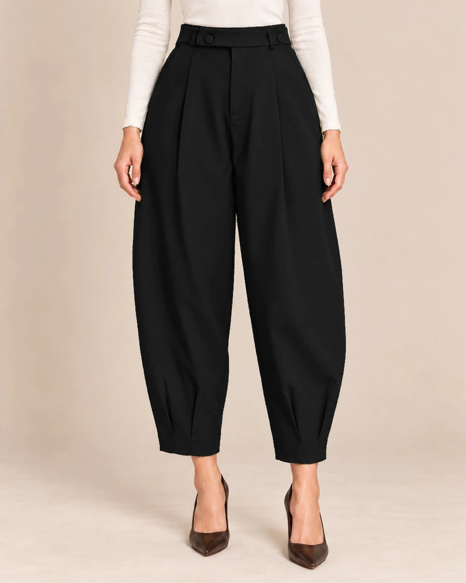 Front detail of black Queen barrel-leg trousers showing the button-detail waistband, front pleats and pleated ankle hems.