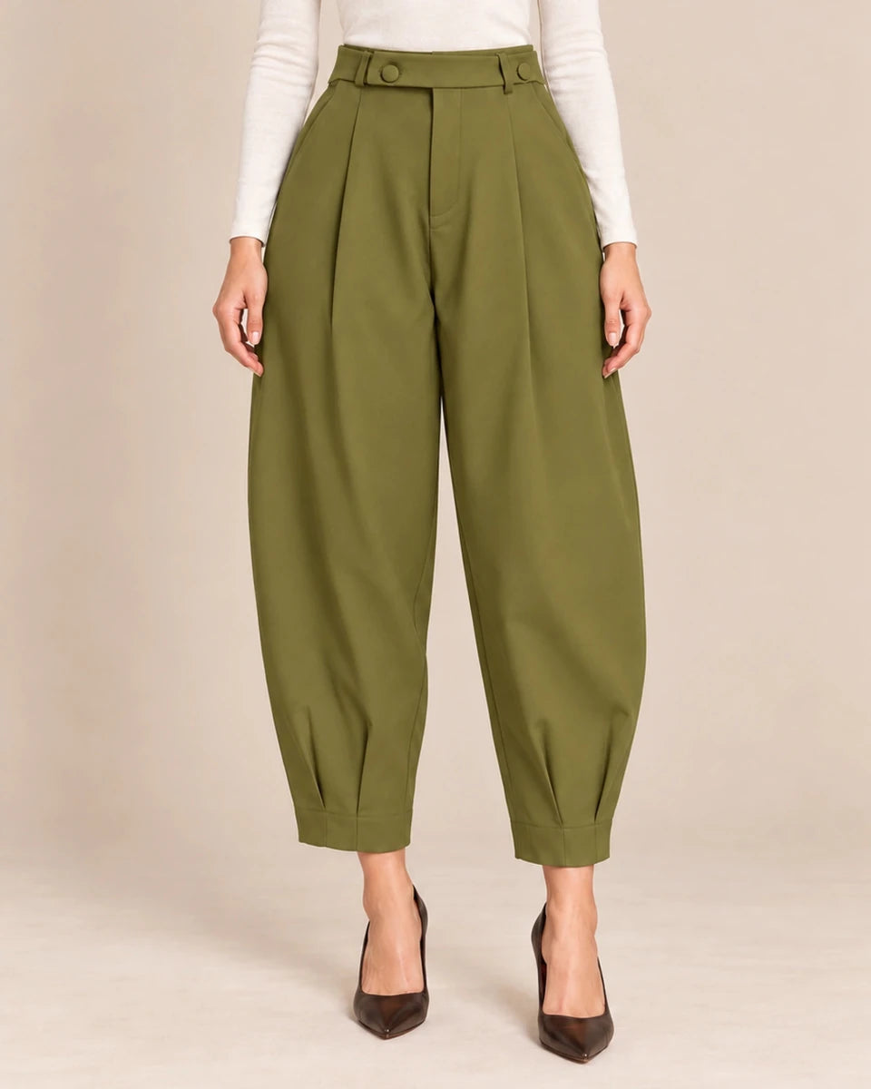 Front detail of olive green Queen barrel-leg trousers showing the button-detail waistband, front pleats and pleated ankle hems.