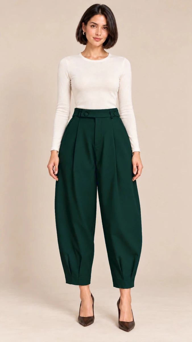 Full-length front view of bottle green Queen barrel-leg trousers with a button-detail waistband and pleated ankle hems, worn with an ivory top.
