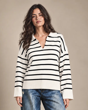 Close-up of Rossana cream-and-black striped sweater showing the open polo-style collar and ribbed hem.
