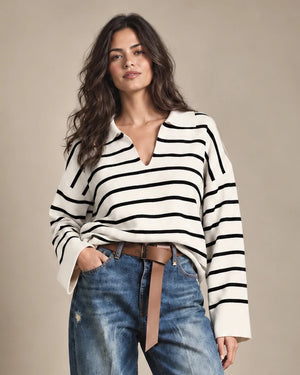 Close-up of the Rossana knit sweater with black horizontal stripes on a cream base and an open polo-style collar.