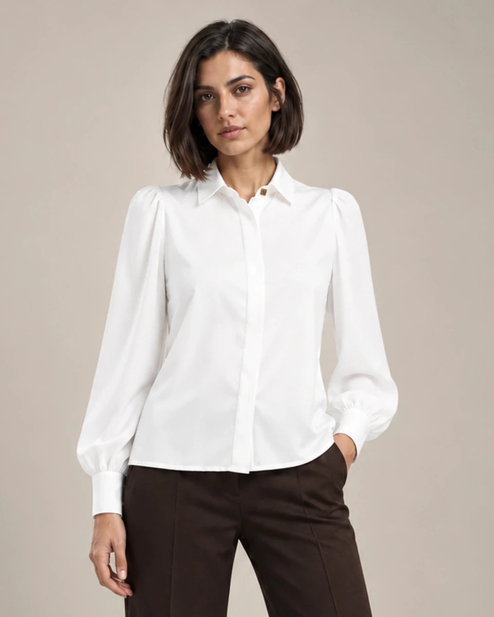 Close-up of the white Serena shirt with a pointed collar, gathered shoulders, long puff sleeves and a concealed front placket.