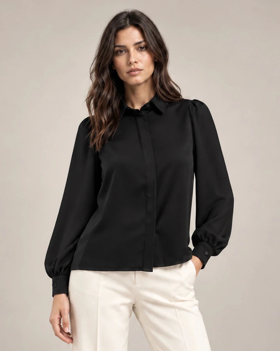 Close-up of the black Serena shirt with a pointed collar, gathered shoulders, long puff sleeves and a concealed front placket.