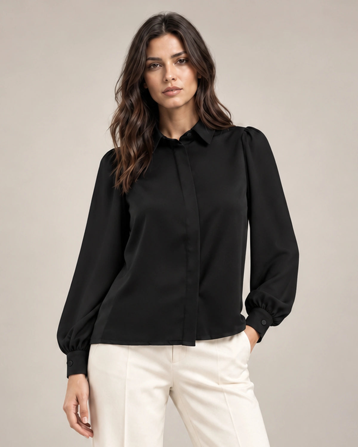 Close-up of the black Serena shirt with a pointed collar, gathered shoulders, long puff sleeves and a concealed front placket.