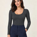 Dark mélange grey stretch-blend deep scoop-neck long-sleeve top styled with navy trousers, front view