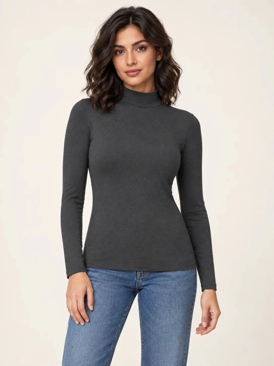 Dark mélange grey stretch-blend mock-neck long-sleeve top worn untucked with blue jeans, front view