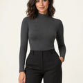Dark mélange grey stretch-blend mock-neck long-sleeve top styled with black trousers, front view