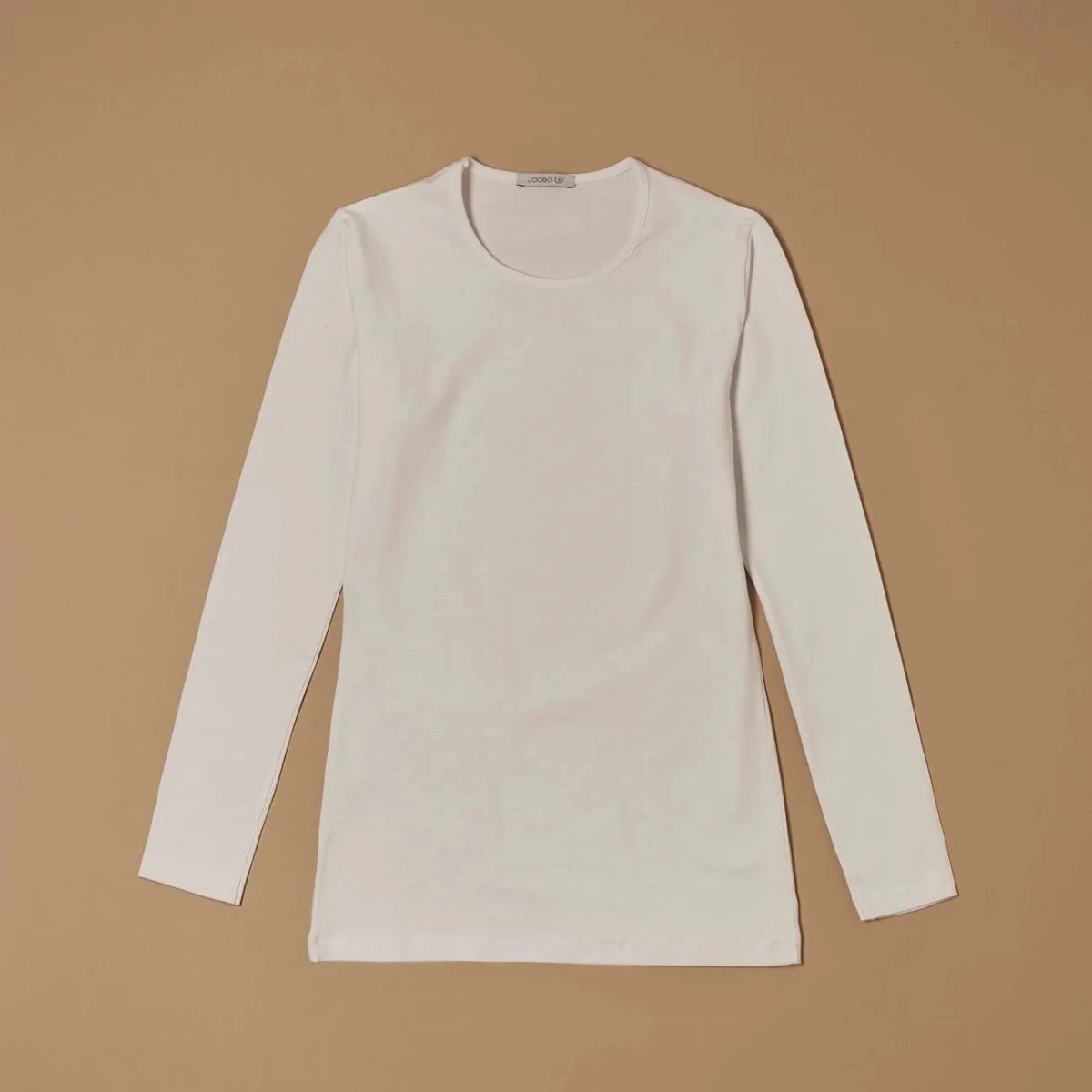 White stretch-cotton crew-neck long-sleeve top laid flat, front view