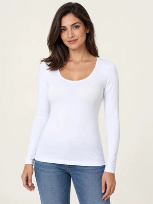 White stretch-cotton deep scoop-neck long-sleeve top worn untucked with blue jeans, front view