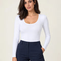 White stretch-cotton deep scoop-neck long-sleeve top styled with navy trousers, front view