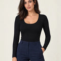 Black stretch-cotton deep scoop-neck long-sleeve top styled with navy trousers, front view