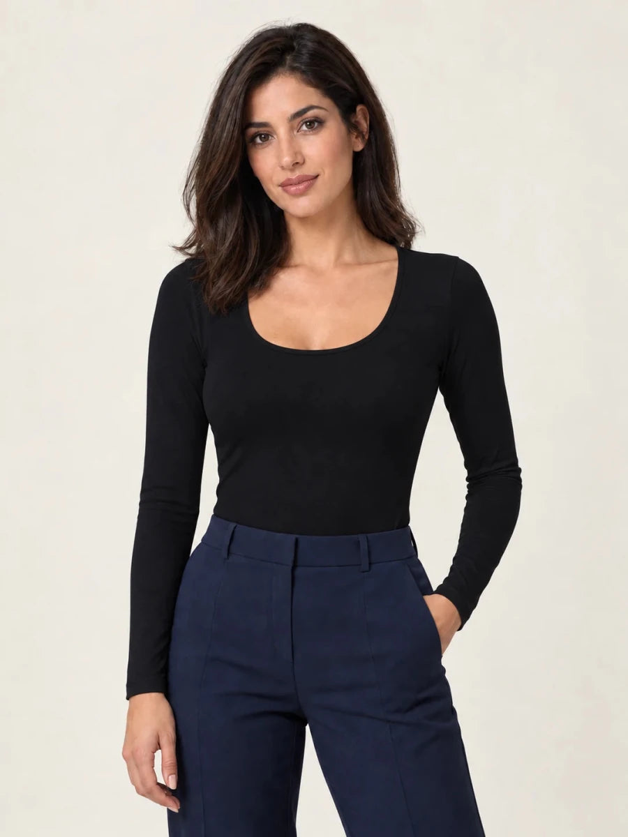 Black stretch-cotton deep scoop-neck long-sleeve top styled with navy trousers, front view