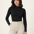 Black stretch-cotton mock-neck long-sleeve top styled with stone trousers, front view