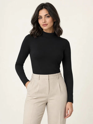 Black stretch-cotton mock-neck long-sleeve top styled with stone trousers, front view