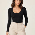 Black stretch-cotton scoop-neck long-sleeve bodysuit styled with stone trousers, front view