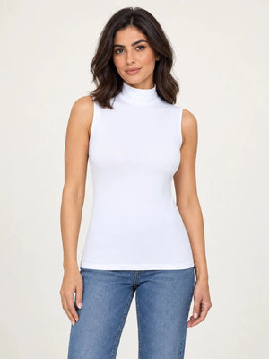 White stretch-cotton sleeveless mock-neck top worn untucked with blue jeans, front view