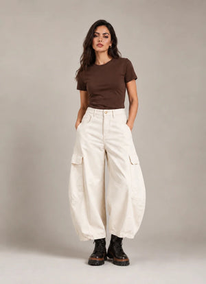Full-length front view of the ivory Vittoria Panna Cargo Balloon Trousers, worn with a brown T-shirt and black ankle boots.