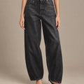 Front detail of the dark-wash Zaira barrel-leg jeans, showing the button waistband, curved front pockets and shaped legs.