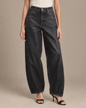 Front detail of the dark-wash Zaira barrel-leg jeans, showing the button waistband, curved front pockets and shaped legs.