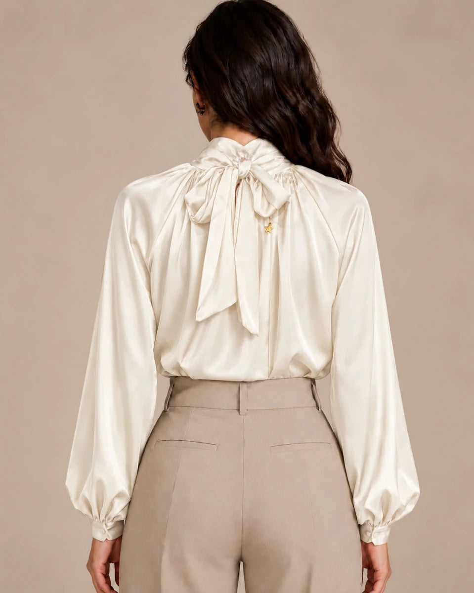 Rear view of the ivory Zendaya Panna gathered-neck shirt showing its neck tie bow and gathered sleeves.