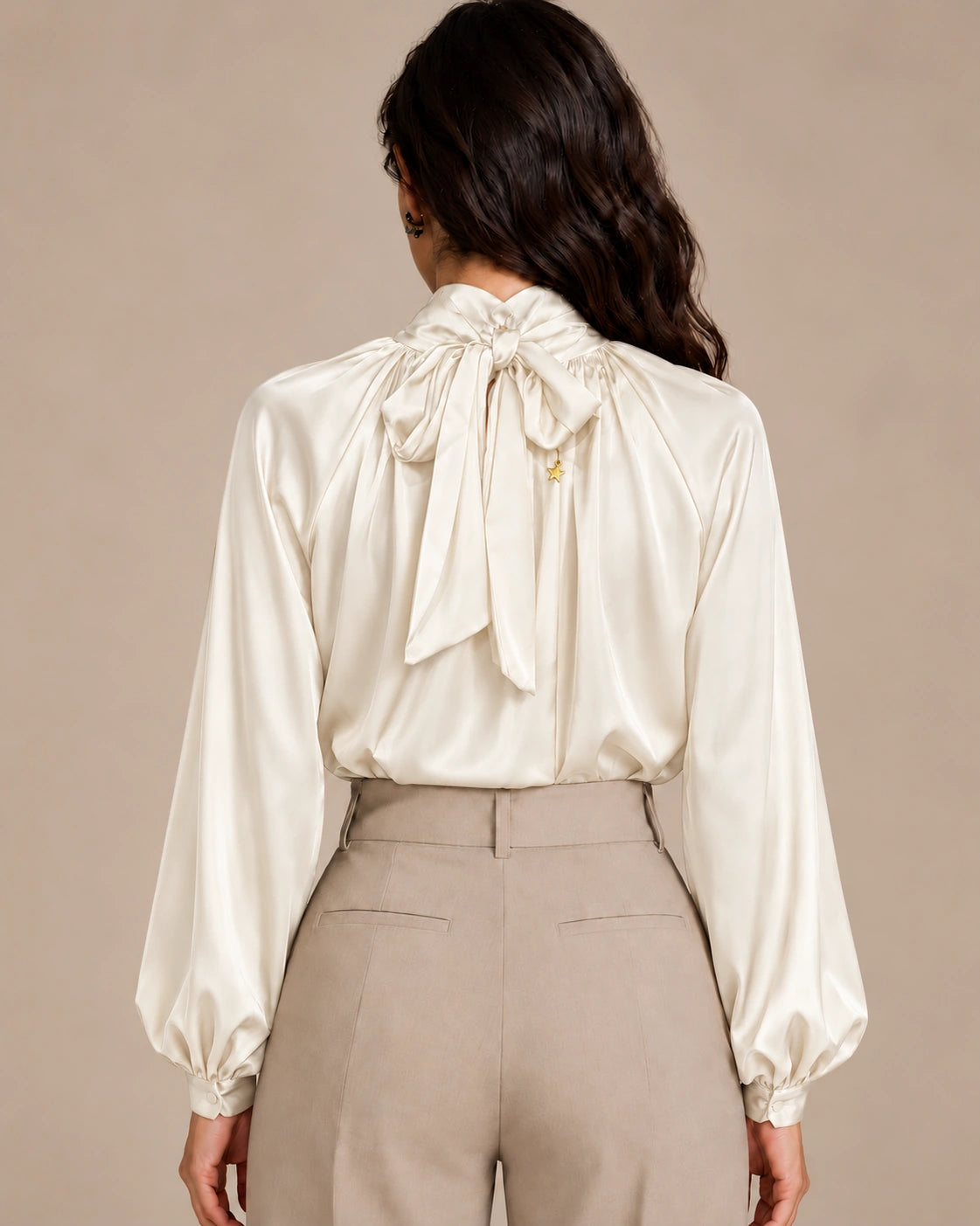 Rear view of the ivory Zendaya Panna gathered-neck shirt showing its neck tie bow and gathered sleeves.