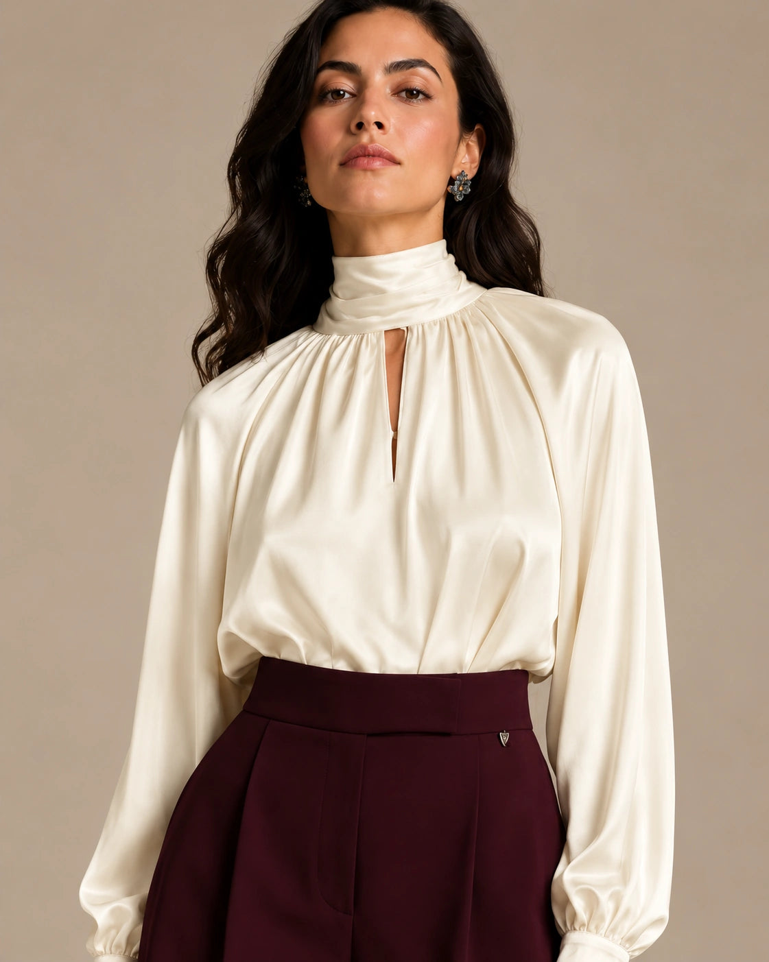Close-up of the ivory Zendaya Panna shirt showing its gathered high neckline, keyhole opening and long sleeves.