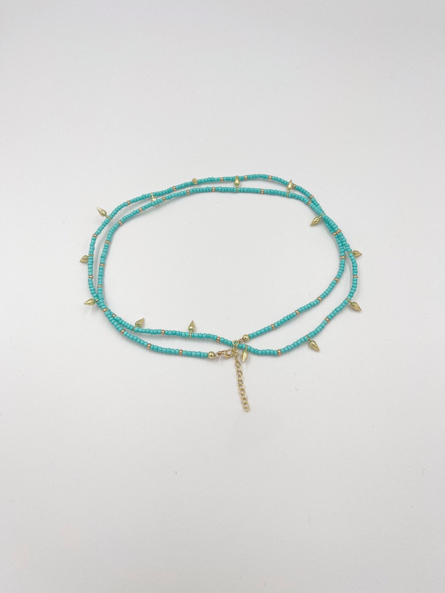 Beads necklace featuring 18 karat gold plated ornaments that can be styled as a bracelet or belt. - ELLY