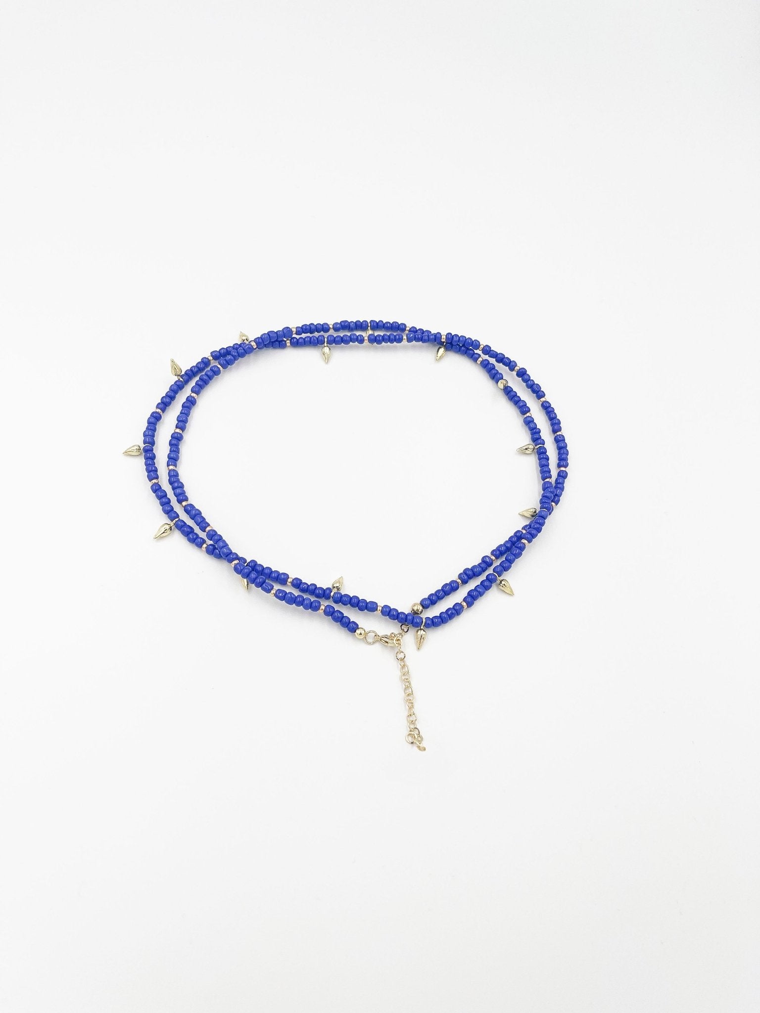 Beads necklace featuring 18 karat gold plated ornaments that can be styled as a bracelet or belt. - ELLY