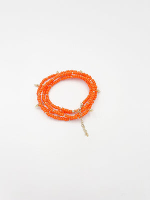 Beads necklace featuring 18 karat gold plated ornaments that can be styled as a bracelet or belt. - ELLY