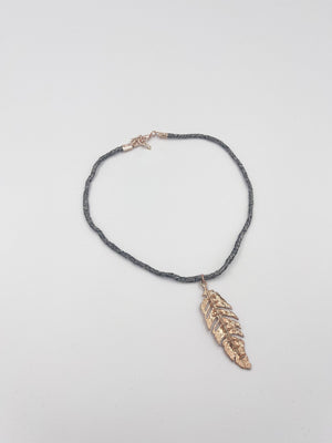 Rhodium coated brass pendant on a metallic string - ELLY